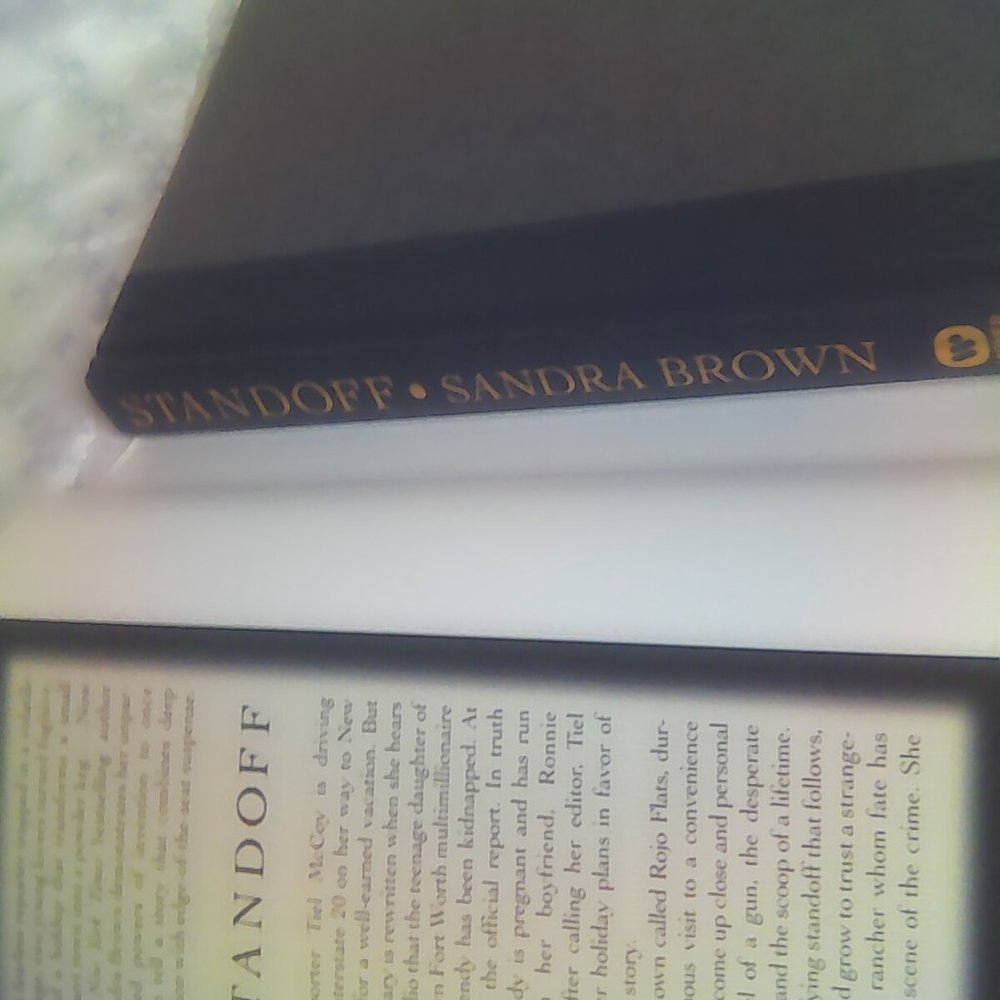 A hardback copy of Sandra Brown s STANDOFF.
